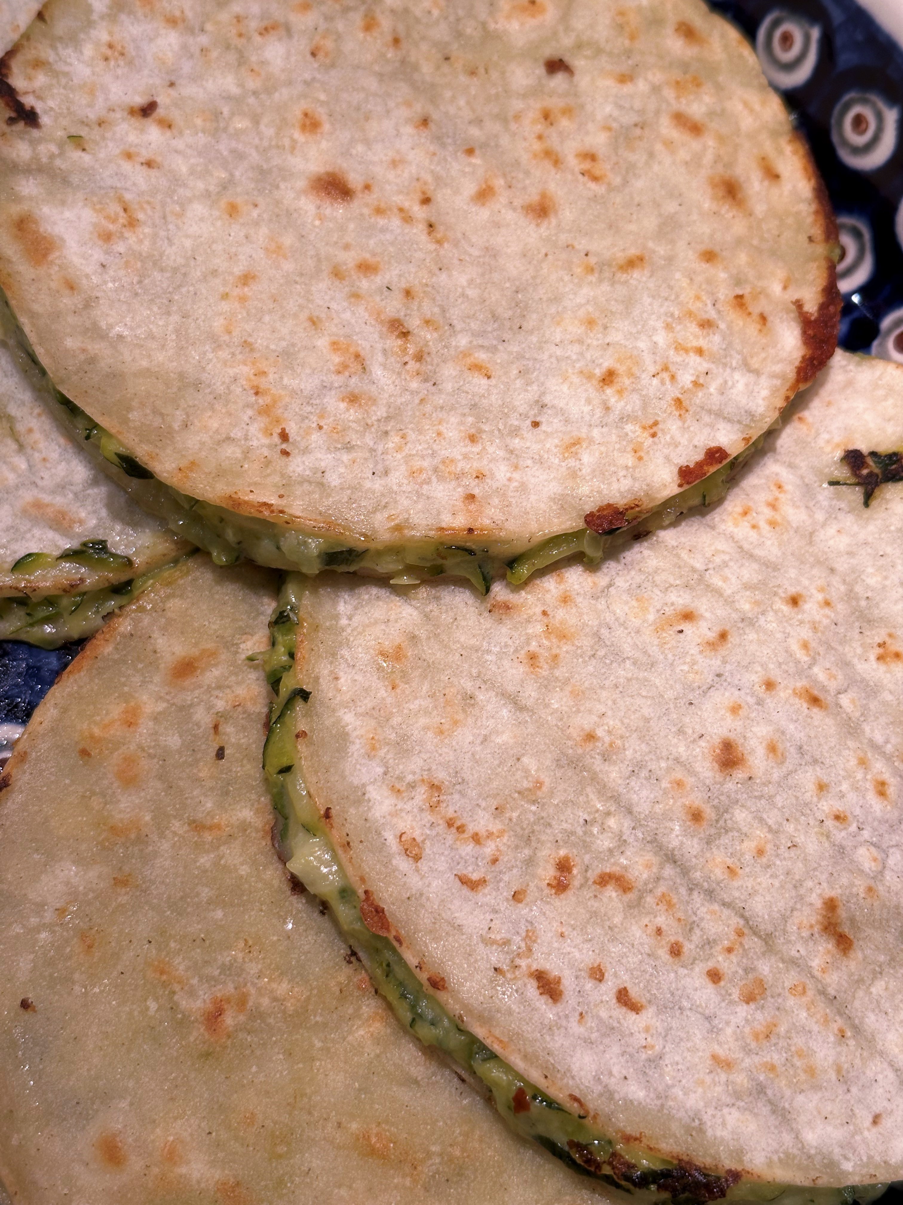 a close up photo of a stack of freshly cooked quesadillas.